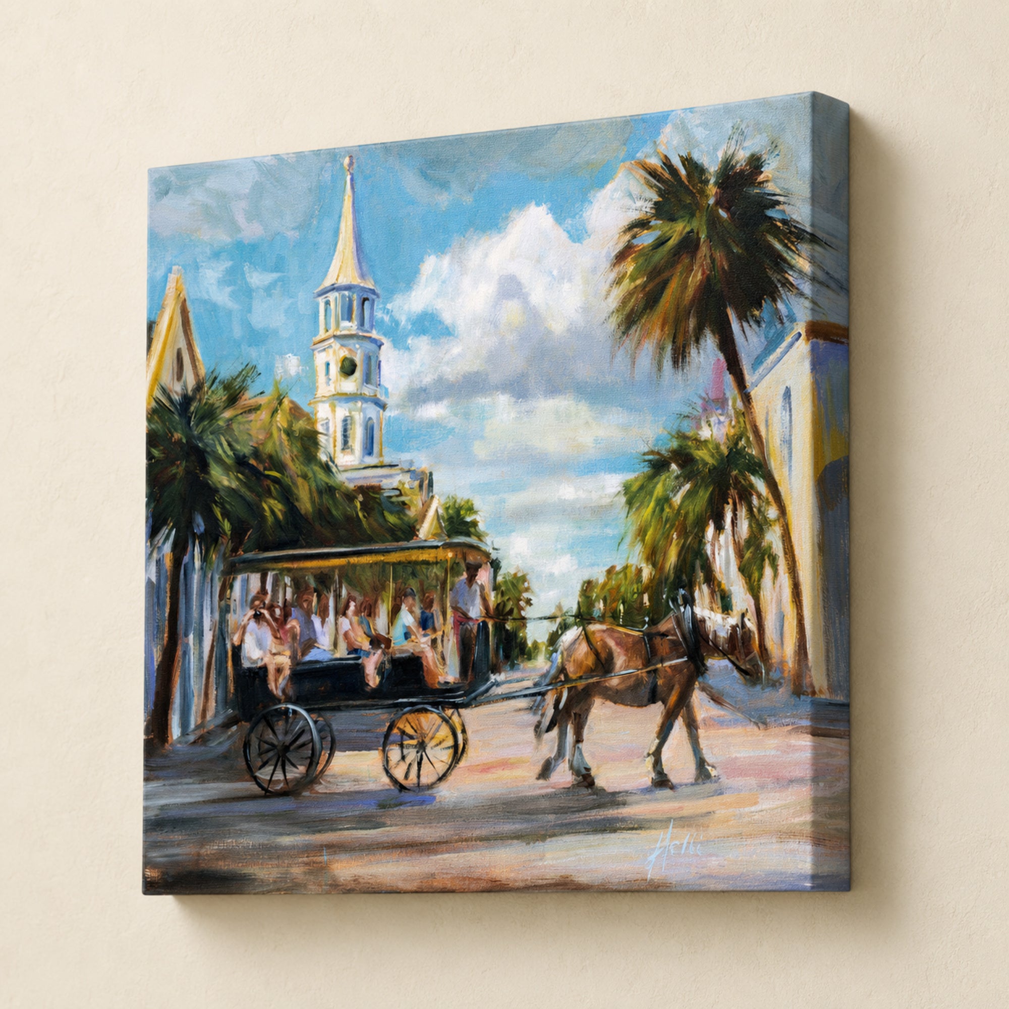 A square canvas wall art print depicting a sunny coastal street scene with a horse-drawn carriage, palm trees, a church steeple, and a blue sky with clouds, shown hanging on a beige wall.